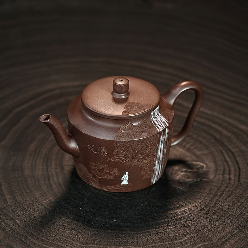 The body of the pot is engraved with a picture of Li Bai, a famous Chinese poet, watching a waterfall. The landscape and mountains complement each other, making it very ornamental.