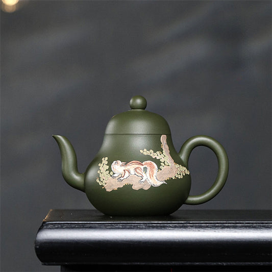 Green teapot with animal prints